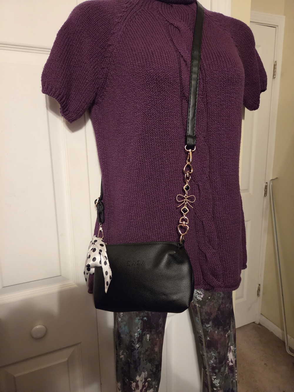 Black Leather Crossbody Bag with Gold Bow Chain Accent